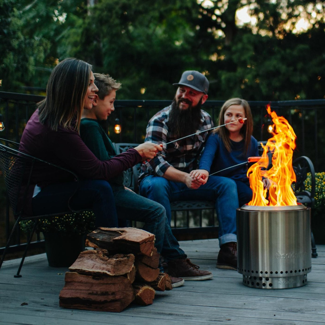 Family sitting around the fire made by their Solo Stove Ranger 2.0 Fire Pit